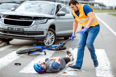 Yaralı bisikletçi ve araba şoförüyle trafik kazası.