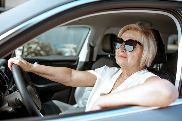 Senior woman driver in the car