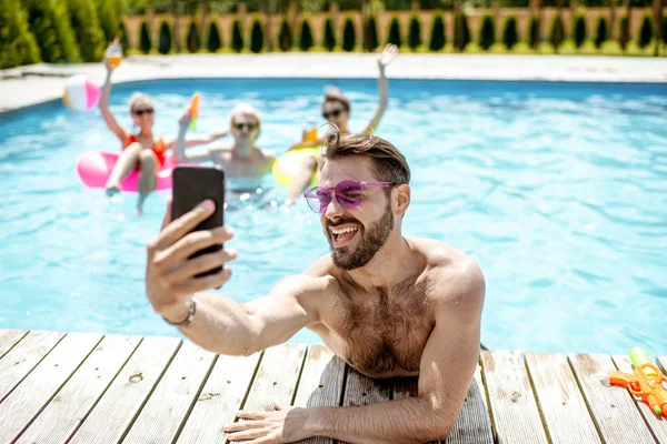 Muž s telefonem v bazénu — Stock fotografie