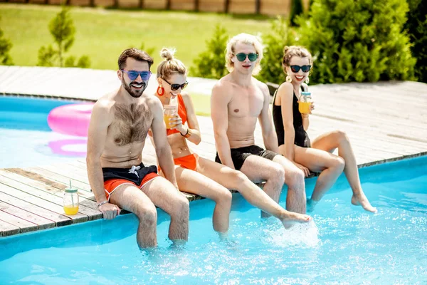 Friends on the swimming pool — Stock Photo, Image