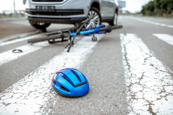 Road accident with car and broken bicycle