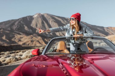 Carefree woman traveling by car