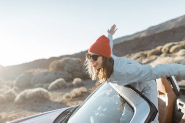 Happy woman traveling by car