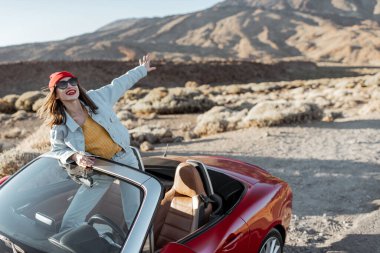 Carefree woman traveling by car