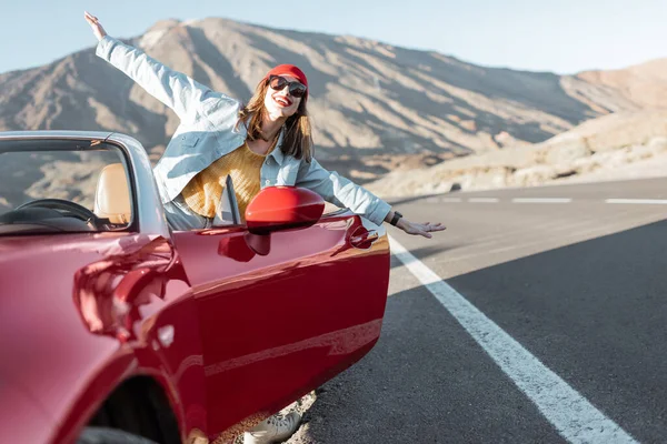 Carefree woman traveling by car