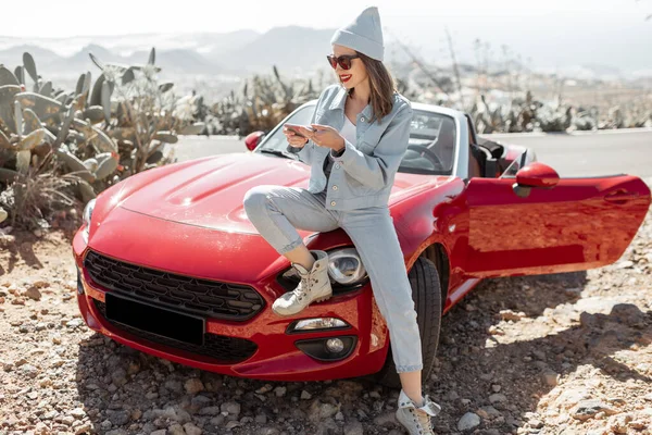 Woman traveling by sports car on the island — Stock Photo, Image