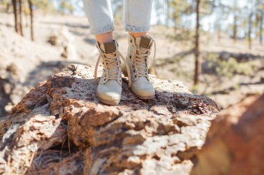 Trekking shoes on a rocky land, close-up