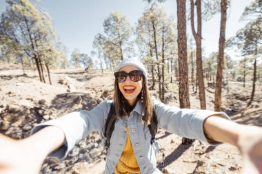 Woman having fun while traveling in the nature