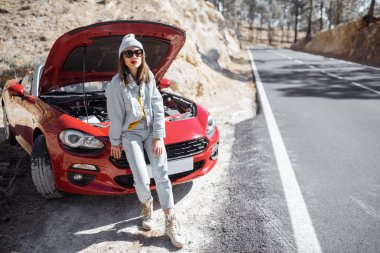 Woman having problems with a car while traveling