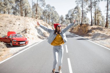 Carefree woman on the mountain road