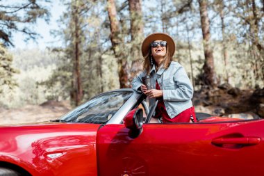 Woman traveling by car on nature