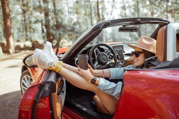 Carefree woman tarveling by car in nature — 图库照片