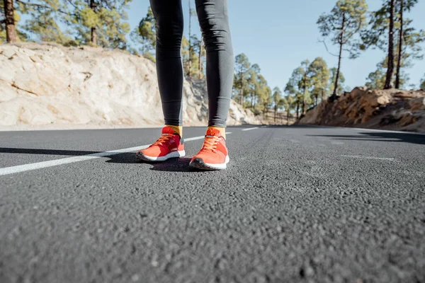 Sports woman in running shoes on the road — Stock Photo, Image