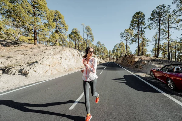Woman jogging on the mountain road