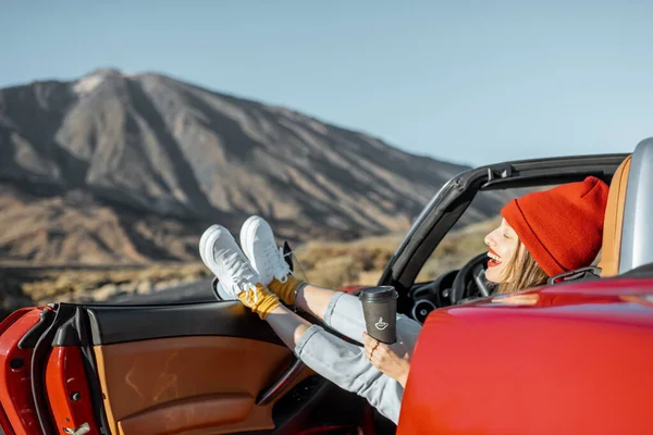 Woman traveling by convertible car on the desert valley — Stock Photo, Image