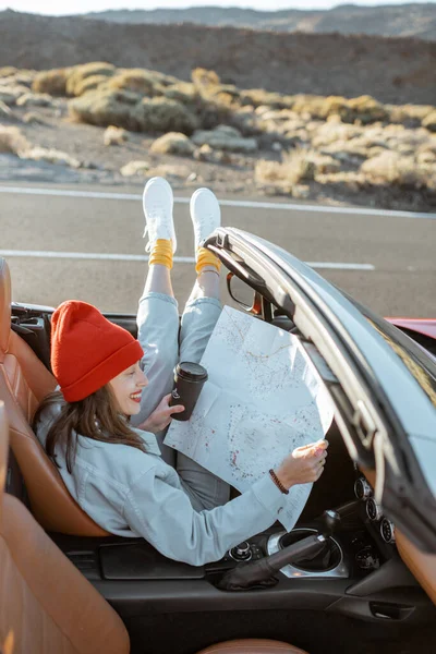 Woman traveling by convertible car on the desert valley — Stock Photo, Image