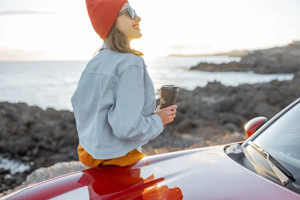 Frau mit Auto an der felsigen Küste unterwegs — Stockfoto