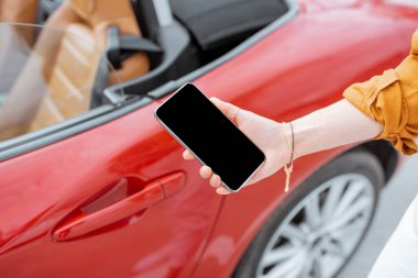 Holding smartphone near the car door
