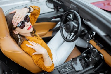 Woman having headache in the car