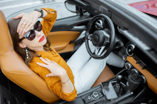 Woman having headache in the car — Stock Fotó