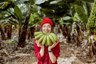Woman with banana stem on the pantation