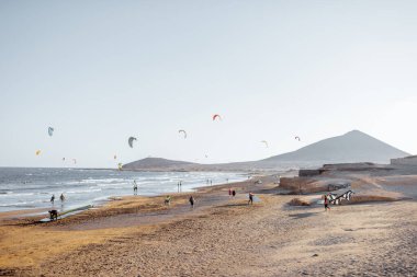 Beach with kite surfers on a sunset