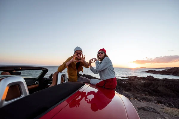 Charmant couple sur la plage, voyageant en voiture — Photo