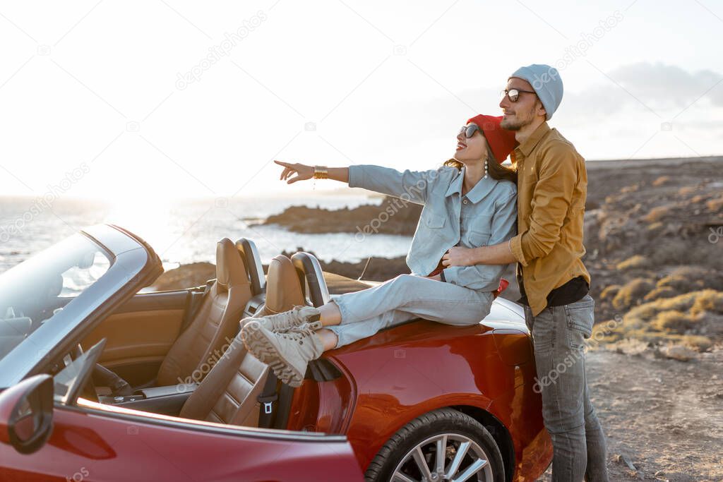 Lovely couple on the beach, traveling by car