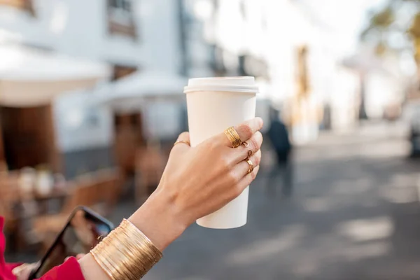 Holding paper cup with coffee to go outdoors — Stock Photo, Image