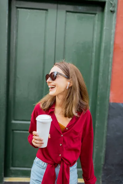 Стильная женщина с кофе на зеленом фоне — стоковое фото