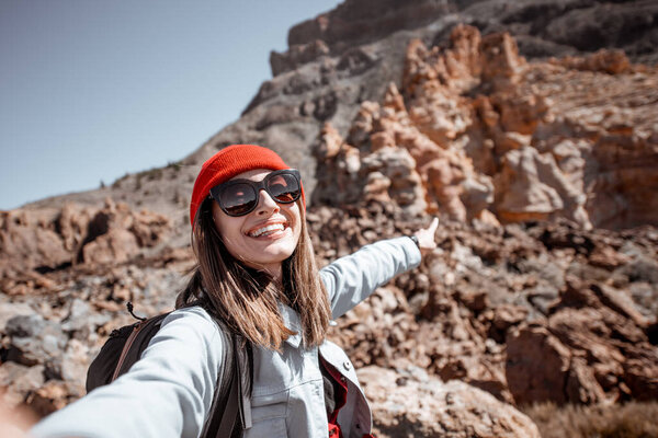 Carefree woman traveling on the rocky terrain