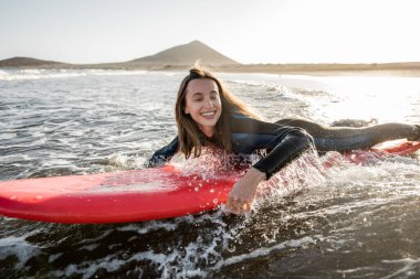 Woman swimming on the surfboard