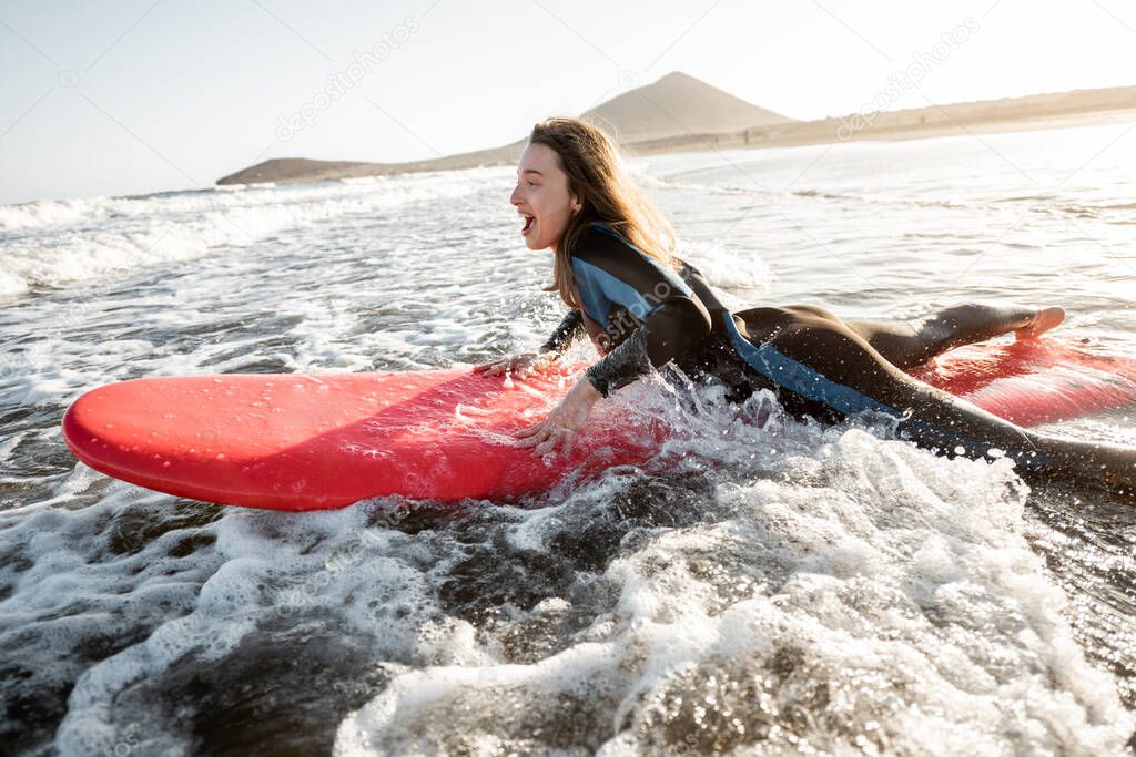 Woman swimming on the surfboard