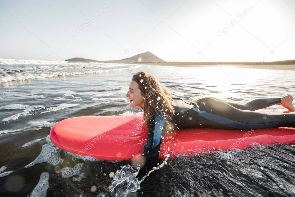 Woman swimming on the surfboard