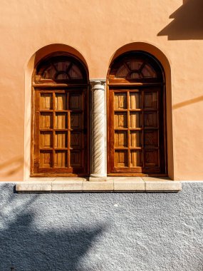 Architectural fragment of the old building with arcj windows