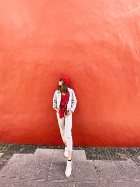 Woman on the red wall background