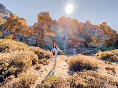 Rocks on the desert valley with woman traveling