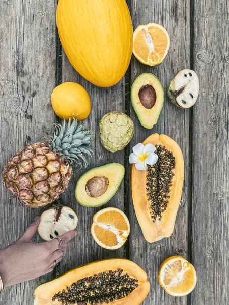 Top view on the wooden table full of exotic fruits and berries