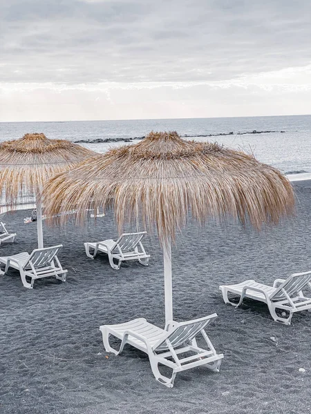Straw umbrellas on the beach resort — Stok fotoğraf