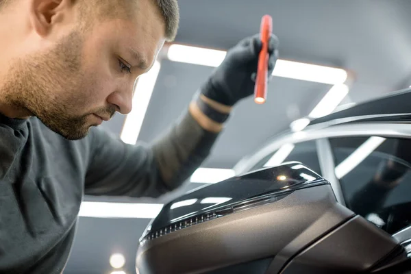 Worker examining vehicle body for scratches — 图库照片