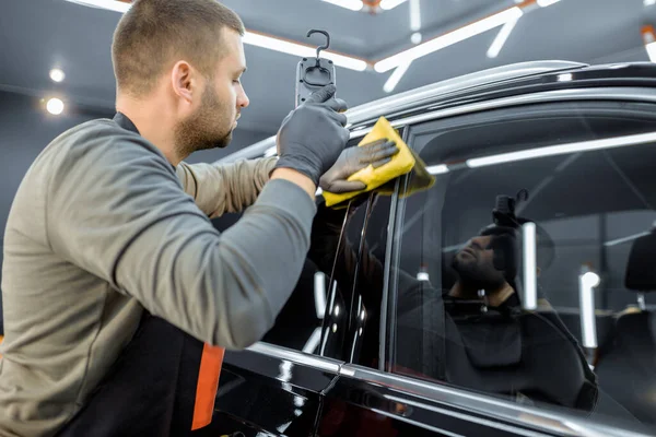 Worker wiping vehicle body with microfiber — Stock Fotó