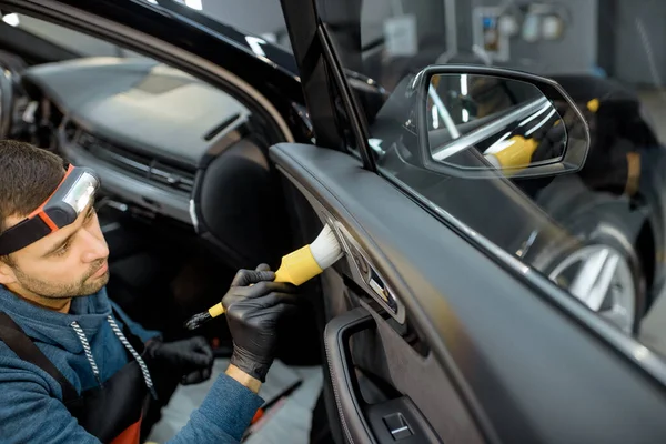 Worker provides professional car interior cleaning — Stock Fotó