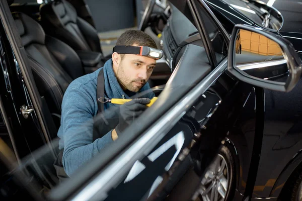 Worker provides professional car interior cleaning — Stock Fotó