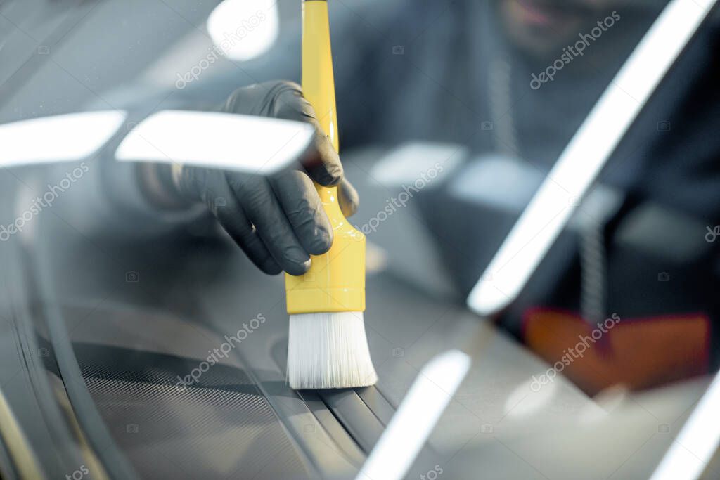 Worker provides professional car interior cleaning