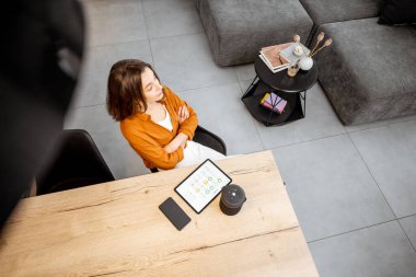 Woman with digital devices for smart home control