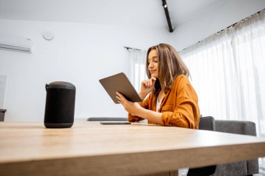 Woman with digital devices for smart home control
