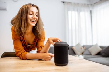 Woman with smart wireless column at home