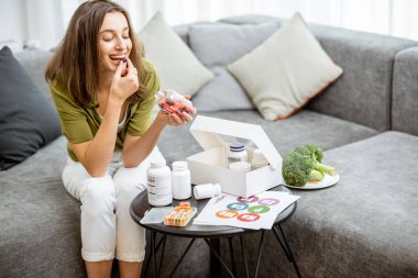 Woman taking vitamins or nutritional supplements