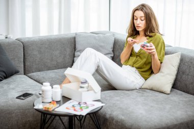 Woman taking vitamins or nutritional supplements