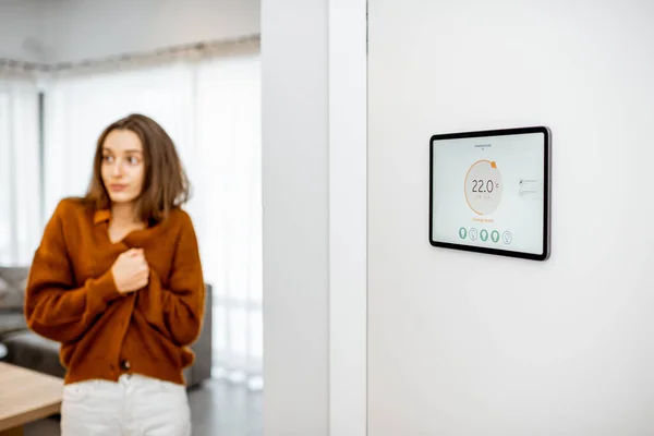 Smart home digital panel with heating app and woman feeling cold — Φωτογραφία Αρχείου